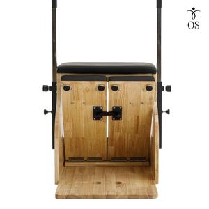 Wooden pilates chair with black cushioned seat on a white background