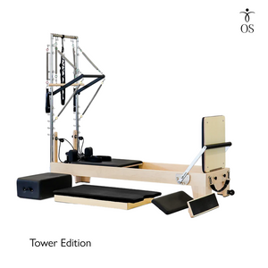 A customizable Pilates reformer machine made of American maple, featuring a black mat, metal bars, and straps.