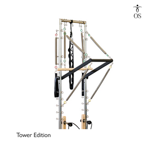 Pilates reformer machine with tower edition label on a white background