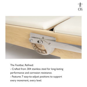 Close-up of a wooden footbar with stainless steel mechanism on maple pilates reformer