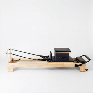 Side profile of the Timber Reformer featuring a durable solid oak frame and low-profile design for boutique studios.