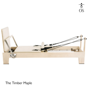 Side view of The Timber Reformer by Oshun Studios featuring a solid light Maple wood frame and custom upholstery.