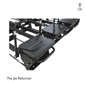 Extra-wide padded carriage on the Jet Reformer with grid markings for precise foot placement during lunges and planks.