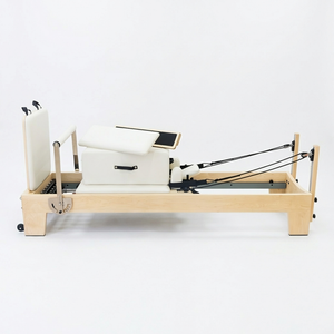 Oshun Studios Timber Reformer in Maple with sitting box raised, showing the complete Pilates reformer profile