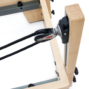 Rope and pulley system on the Maple frame of the Oshun Studios Timber Reformer for balanced tension