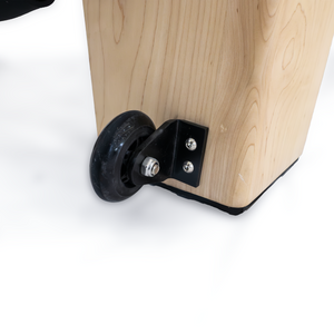 Transport wheel on the Maple frame corner of the Oshun Studios Timber Reformer for easy studio mobility