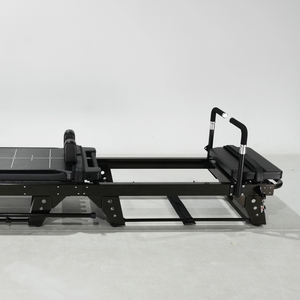 Black Pilates reformer on a white background