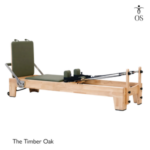 Full side profile view of the Timber Reformer in solid Oak, displaying the sleek frame design and sturdy low-profile stance.