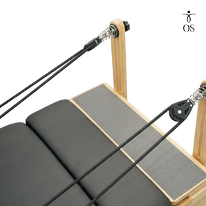 Close-up of the smooth swivel pulleys on the riser system to prevent rope friction during exercises.