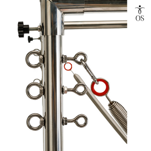 Close-up of the stainless steel Cadillac tower uprights featuring multiple eyelet attachment points for precise spring height adjustment.