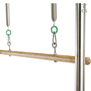 Solid wood roll-down bar attached to green resistance springs on the Timber Cadillac Tower, featuring heavy-duty carabiner connections.