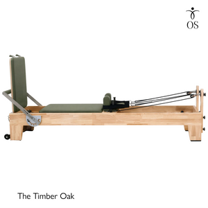 Side view of The Timber Reformer by Oshun Studios featuring a solid Oak wood frame and custom upholstery.