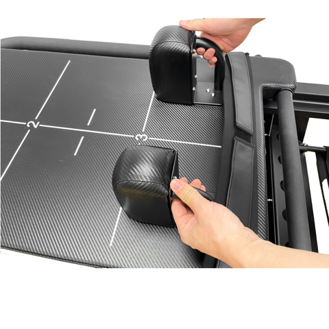 Adjustable padded headrest on the black Jet Reformer, providing essential neck support during high-intensity supine Pilates exercises.