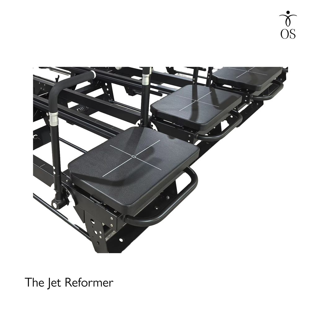 Extra-wide padded carriage on the Jet Reformer with grid markings for precise foot placement during lunges and planks.