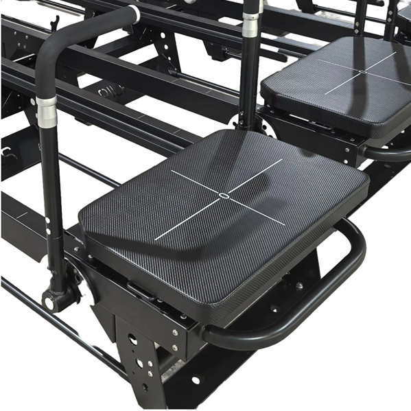 Extra-wide padded carriage on the Jet Reformer with grid markings for precise foot placement during lunges and planks.