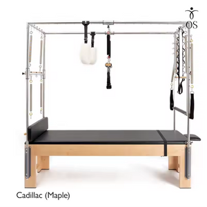 The Timber Cadillac in solid Maple. A professional Pilates Trapeze Table with a light wood finish and stainless steel tower.