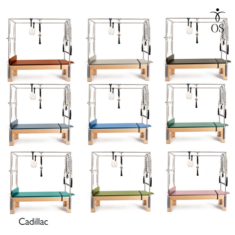 The Timber Cadillac in solid Maple. A professional Pilates Trapeze Table with a light wood finish and stainless steel tower.