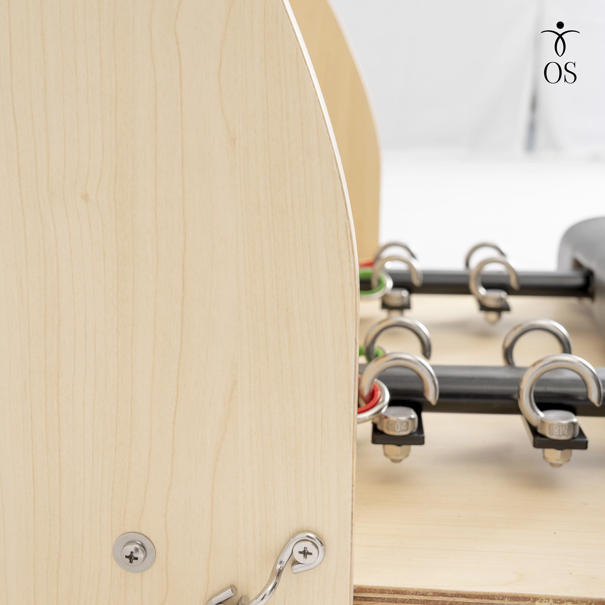 Close-up of the heavy-duty steel spring anchor points on the Maple Timber Chair, ensuring secure resistance attachment for advanced Pilates work.