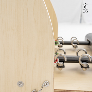 Close-up of the heavy-duty steel spring anchor points on the Maple Timber Chair, ensuring secure resistance attachment for advanced Pilates work.