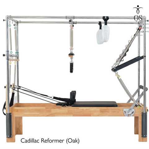 The Timber Cadillac Reformer in solid Oak. A versatile all-in-one Pilates machine combining a studio reformer with a full trapeze tower.