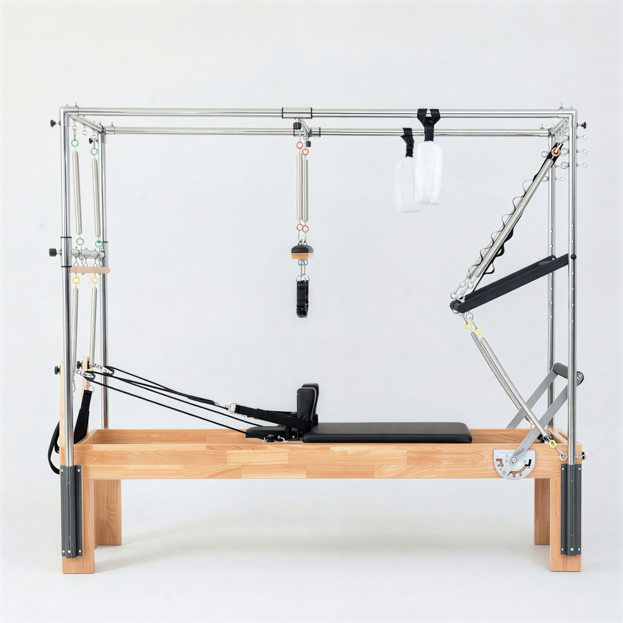 The Timber Cadillac Reformer in solid Oak. A versatile all-in-one Pilates machine combining a studio reformer with a full trapeze tower.