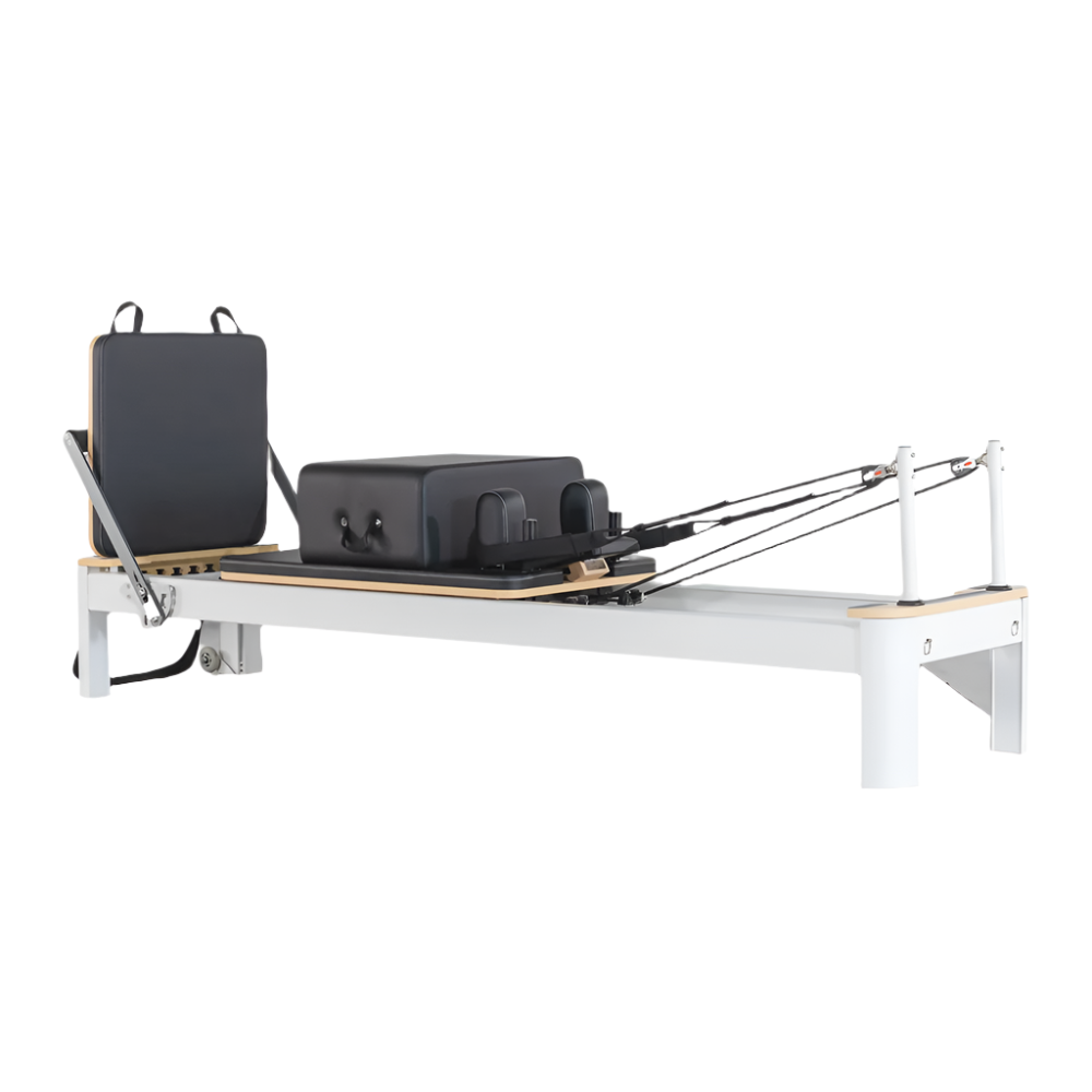 Oshun Origin Reformer with white frame and black upholstery, jump board and sitting box