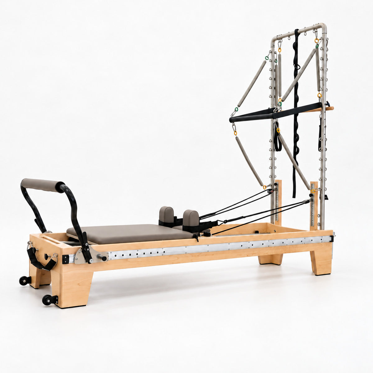 Oshun Timber Therapy Reformer Tower Edition in maple with taupe upholstery, a half tower and the sliding footbar on its aluminum side rail