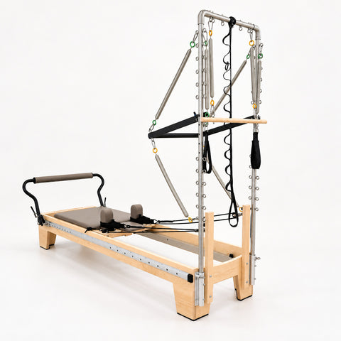 Head end of the Oshun Timber Therapy Reformer Tower Edition, with the half tower mounted to the maple frame
