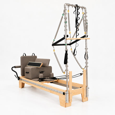 Oshun Timber Therapy Reformer Tower Edition in maple with taupe upholstery, sitting box and jump board