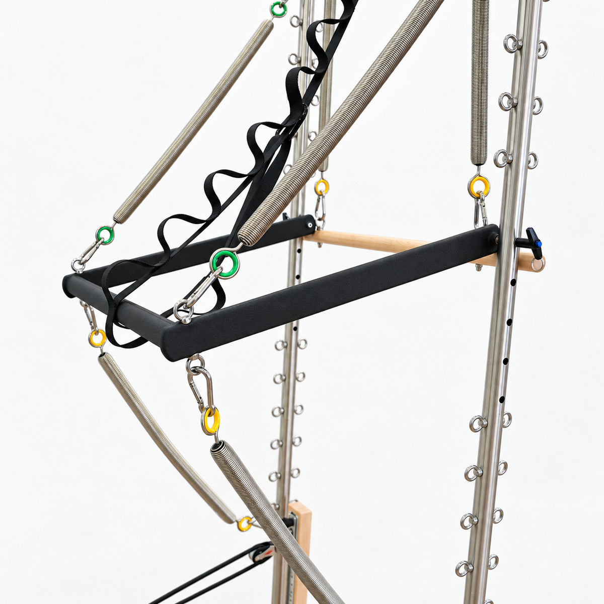Push-through bar and maple roll-down bar on the half tower of the Oshun Timber Therapy Reformer, with color-coded springs