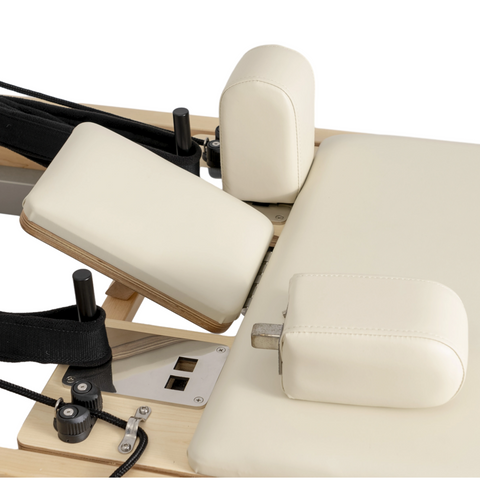Close-up of the adjustable headrest and padded shoulder rests on the Oshun Timber Reformer