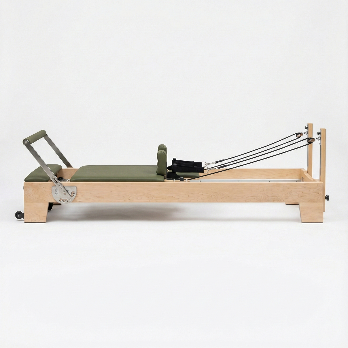 Oshun Timber Reformer in maple with olive green upholstery, side view on a white background