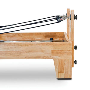 Solid oak frame and rope pulley uprights of the Oshun Timber Reformer