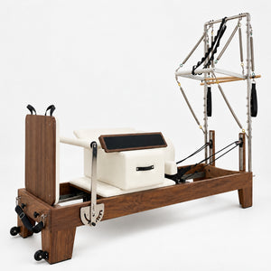 Oshun Timber Reformer Tower Edition in solid walnut with ivory upholstery, half tower, sitting box and jump board