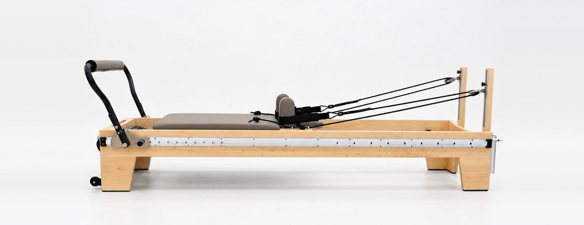The Oshun Timber Therapy Reformer at Studio Height, a 13.4 in maple frame, side view